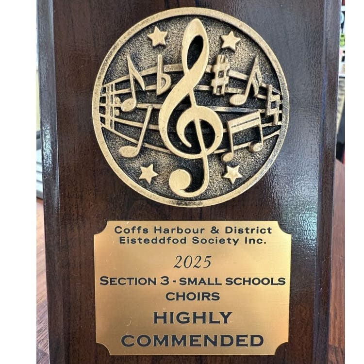 Round abstract musical image on wooden rectangular trophy with gold plaque reading